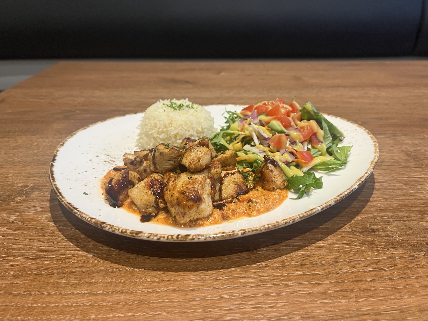 Grilled chicken on rice with salad and romesco sauce at Casa Victoria